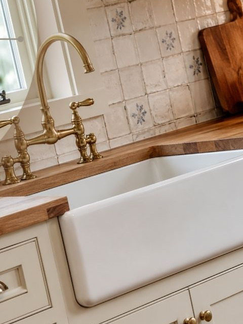 Farmhouse kitchen: maple butcher-block, brass faucet, and painted cabinets from a Truth Build job